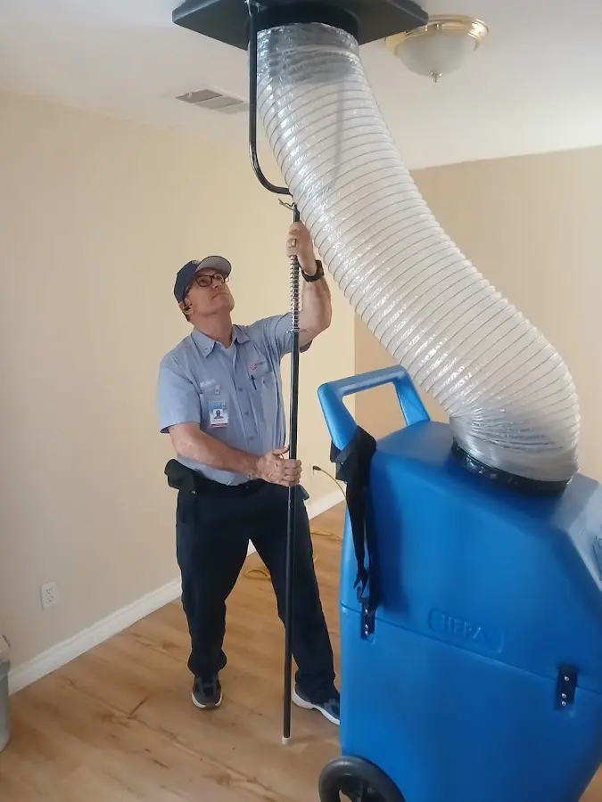 Furnace Tune-Up technician using HEPA equipment in Sky Lake